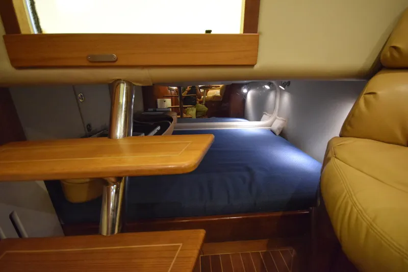 Slide: The Image of Interior cabin of 2009 Jupiter 39 Express with wooden steps and cozy sleeping area. - 27