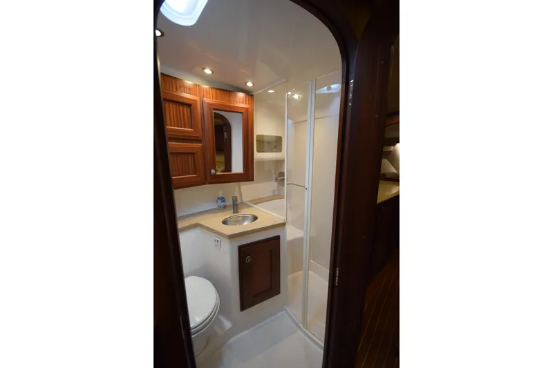 Slide: The Image of 2009 Jupiter 39 Express yacht bathroom with wooden cabinets and modern fixtures. - 28