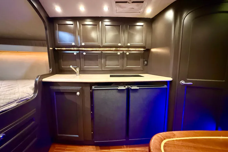Slide: The Image of Luxurious interior of 2009 Jupiter 39 Express yacht with sleek cabinetry and ambient lighting. - 29