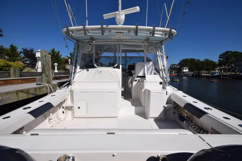 Slide: The Image of 2009 Jupiter 39 Express boat docked, showcasing spacious deck and fishing equipment. - 4