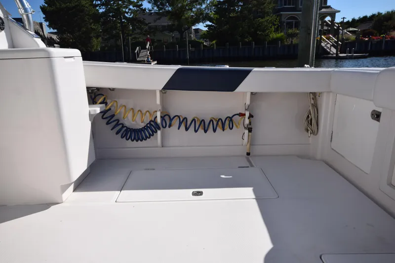 Slide: The Image of 2009 Jupiter 39 Express boat deck with coiled hoses and storage compartments. - 6