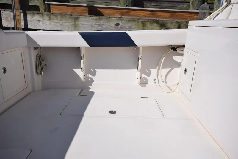 Slide: The Image of 2009 Jupiter 39 Express boat deck with storage compartments and clean white finish. - 7