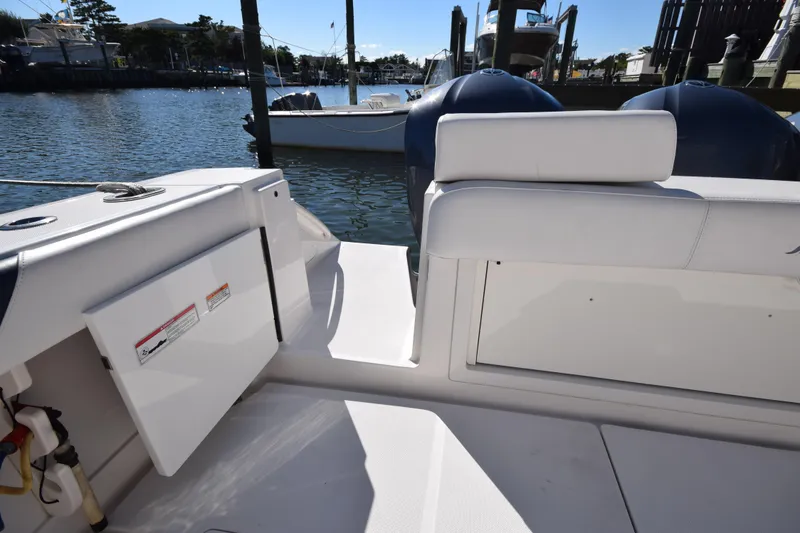 Slide: The Image of 2009 Jupiter 39 Express boat interior with seating and storage, docked by the water. - 9