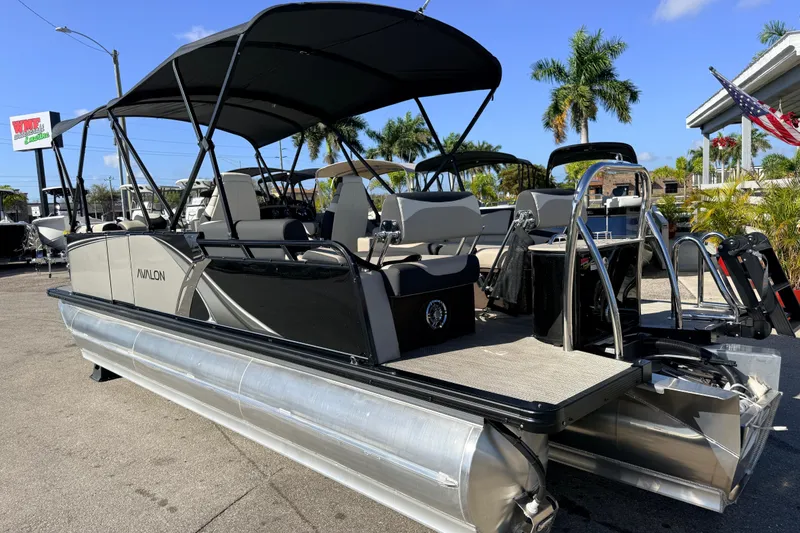 Slide: The Image of 2026 Avalon 2585 LSZ Quad Lounger Shift Tri Toon boat, high performance, parked outdoors. - 10