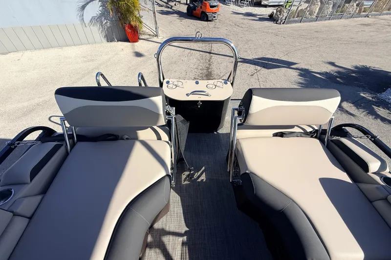 Slide: The Image of 2026 Avalon 2585 LSZ Quad Lounger boat interior with plush seating and control console. - 23