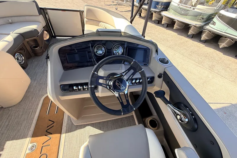 Slide: The Image of 2026 Avalon 2585 LSZ Quad Lounger boat dashboard with steering wheel and controls. - 25
