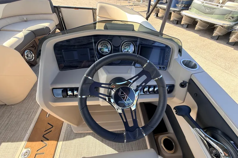 Slide: The Image of Steering console of 2026 Avalon 2585 LSZ Quad Lounger, featuring modern controls and dashboard. - 26