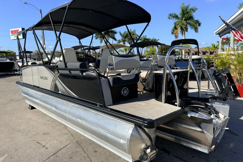 Slide: The Image of 2026 Avalon 2585 LSZ Quad Lounger Tri Toon boat, high performance, parked outdoors. - 9