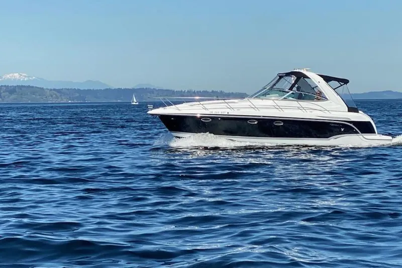 The Image of 2007 Formula 34 Performance Cruiser on open water with scenic mountain backdrop. - 0