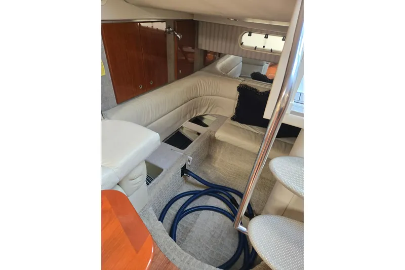 Slide: The Image of Interior of 2007 Formula 34 Performance Cruiser with beige seating and wooden cabinetry. - 9