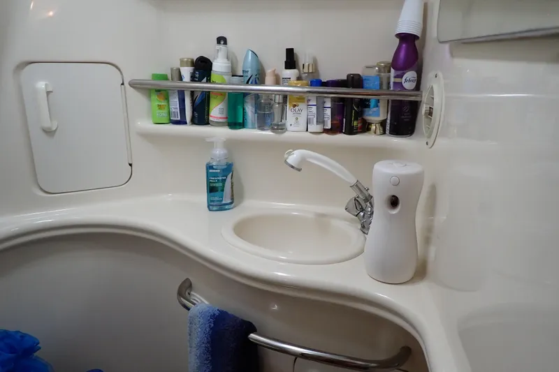 Slide: The Image of Bathroom sink area on a 2002 Sea Ray 340 Sundancer yacht with toiletries. - 100
