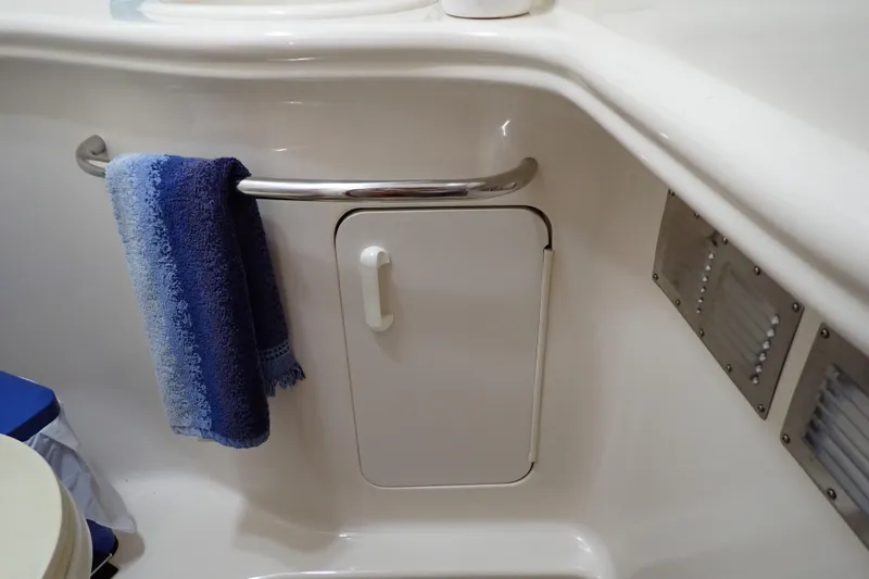 Slide: The Image of 2002 Sea Ray 340 Sundancer bathroom with towel rack and storage compartment. - 103