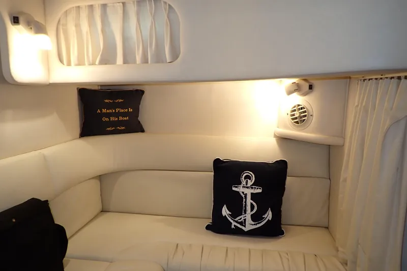 Slide: The Image of Cozy interior of 2002 Sea Ray 340 Sundancer with nautical-themed pillows. - 110