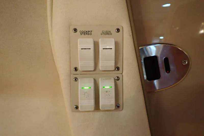 Slide: The Image of Control panel on 2002 Sea Ray 340 Sundancer yacht, featuring cockpit and cabin stereo switches. - 117