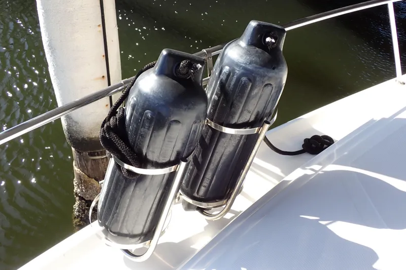 Slide: The Image of Boat fenders on a 2002 Sea Ray 340 Sundancer, docked by the water. - 129