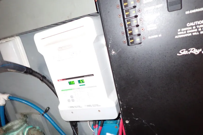 Slide: The Image of Electrical panel and components inside a 2002 Sea Ray 340 Sundancer boat. - 144