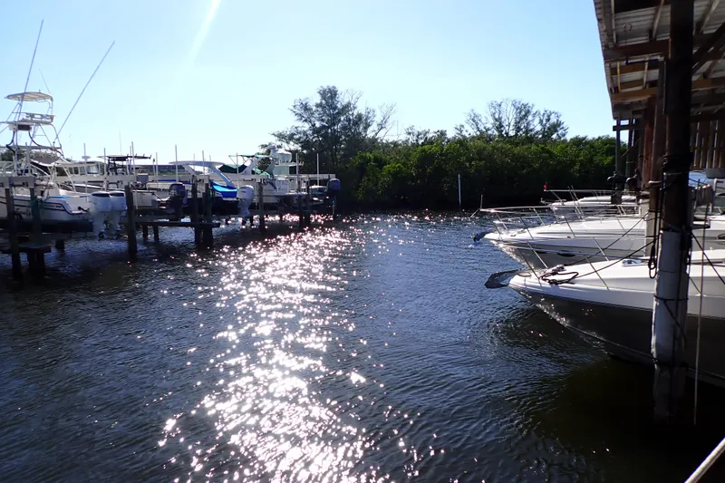 Slide: The Image of Boats docked at marina, including 2002 Sea Ray 340 Sundancer, under sunny sky. - 147