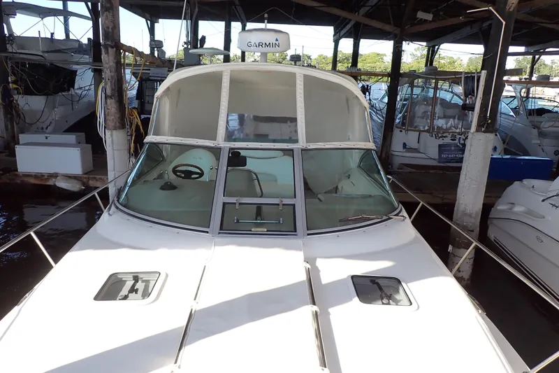 Slide: The Image of 2002 Sea Ray 340 Sundancer docked in a marina, featuring a Garmin navigation system. - 15