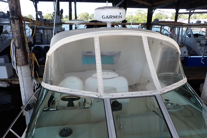 Slide: The Image of 2002 Sea Ray 340 Sundancer boat with Garmin equipment docked in a marina. - 18
