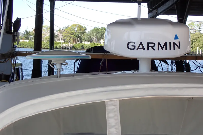 Slide: The Image of 2002 Sea Ray 340 Sundancer with Garmin radar, docked under a covered marina. - 19