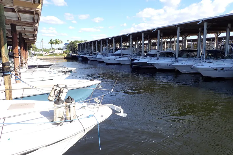 Slide: The Image of Boats docked at marina, featuring a 2002 Sea Ray 340 Sundancer under a sunny sky. - 24