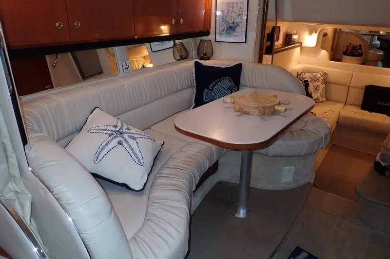 Slide: The Image of Interior of 2002 Sea Ray 340 Sundancer yacht with cozy seating and nautical decor. - 27