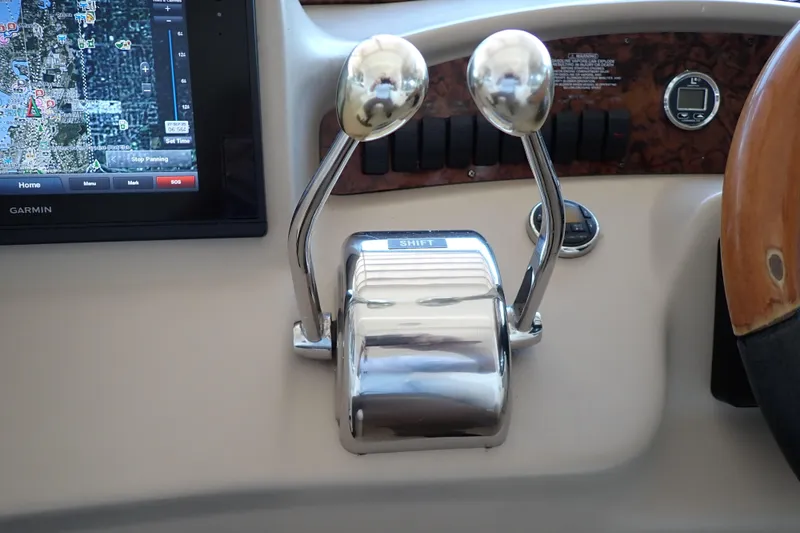 Slide: The Image of Control panel of a 2002 Sea Ray 340 Sundancer with GPS and throttle levers. - 43