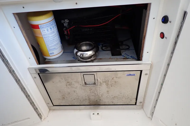 Slide: The Image of Storage compartment on a 2002 Sea Ray 340 Sundancer boat with cleaning supplies and equipment. - 49