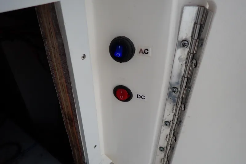Slide: The Image of AC and DC switches on a 2002 Sea Ray 340 Sundancer boat panel. - 51