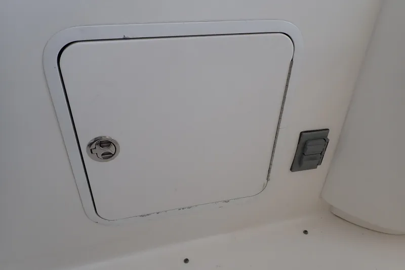 Slide: The Image of Access panel on 2002 Sea Ray 340 Sundancer boat, featuring a latch and adjacent switch. - 54
