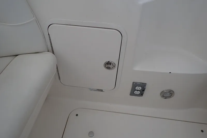 Slide: The Image of 2002 Sea Ray 340 Sundancer interior with storage compartment and electrical outlet. - 58