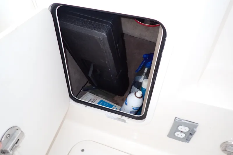 Slide: The Image of Storage compartment on a 2002 Sea Ray 340 Sundancer boat with cleaning supplies. - 59