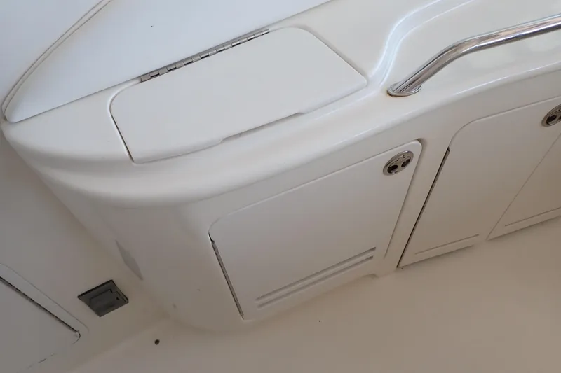 Slide: The Image of 2002 Sea Ray 340 Sundancer boat interior with storage compartments and stainless steel handle. - 60