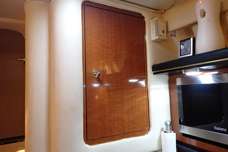 Slide: The Image of Interior of 2002 Sea Ray 340 Sundancer with wooden cabinet and modern appliances. - 64