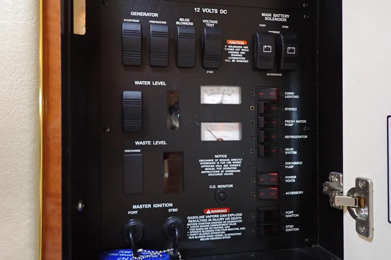 Slide: The Image of Control panel of a 2002 Sea Ray 340 Sundancer boat, featuring various switches and gauges. - 67