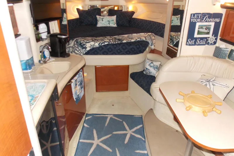 Slide: The Image of Interior of 2002 Sea Ray 340 Sundancer yacht with cozy seating and nautical decor. - 7