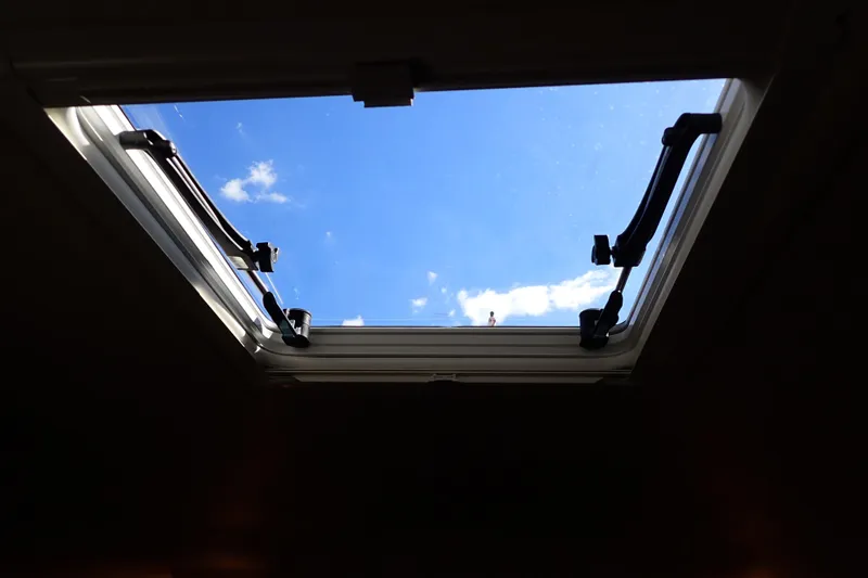 Slide: The Image of Open hatch view from 2002 Sea Ray 340 Sundancer, showcasing blue sky and clouds. - 84