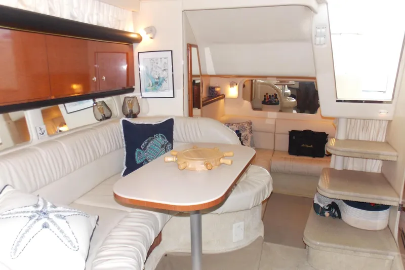 Slide: The Image of Interior of 2002 Sea Ray 340 Sundancer yacht with cozy seating and nautical decor. - 9