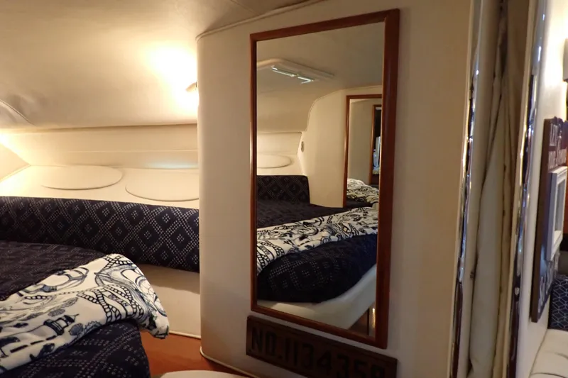 Slide: The Image of Interior cabin of 2002 Sea Ray 340 Sundancer with mirror and patterned bedding. - 91