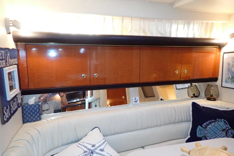 Slide: The Image of Interior of 2002 Sea Ray 340 Sundancer with wooden cabinets and nautical decor. - 94