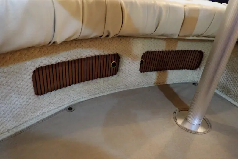 Slide: The Image of Interior view of 2002 Sea Ray 340 Sundancer boat with cushioned seating and wooden accents. - 97