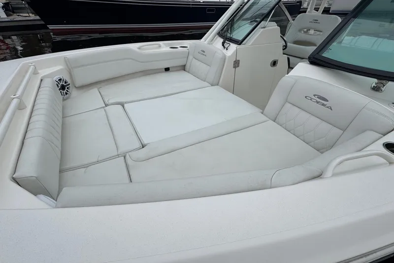 Slide: The Image of 2024 Cobia 240 Dual Console boat with spacious white seating area. - 20