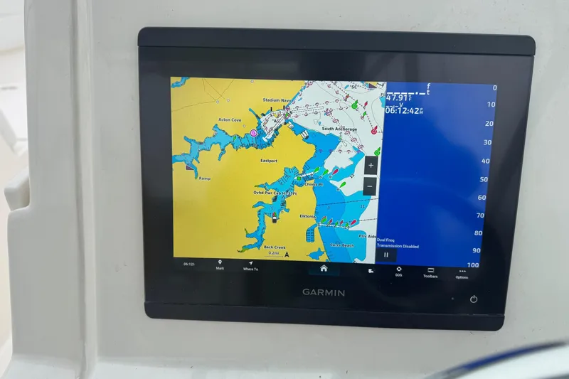 Slide: The Image of Garmin navigation display on 2024 Cobia 240 Dual Console boat, showing detailed marine map. - 21