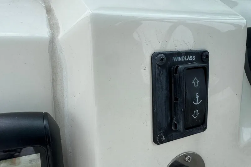 Slide: The Image of 2024 Cobia 240 Dual Console windlass control switch on boat dashboard. - 29
