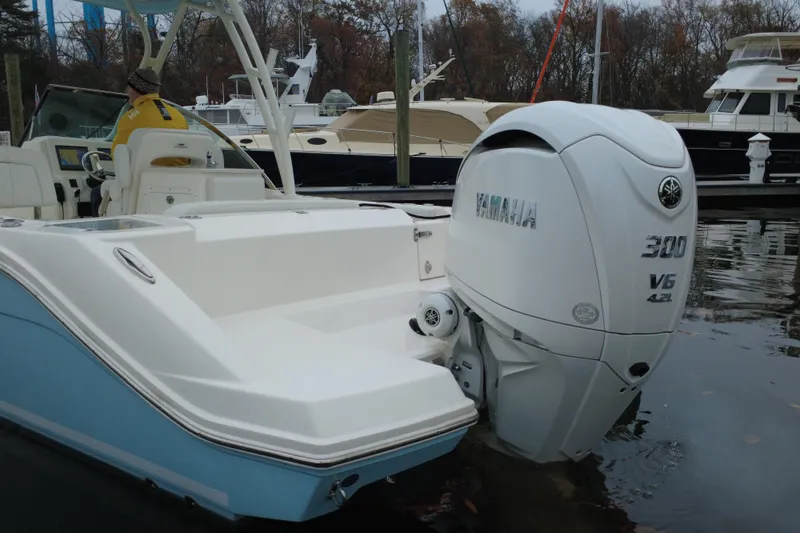 Slide: The Image of 2024 Cobia 240 Dual Console with Yamaha 300 V6 outboard engine at marina. - 4