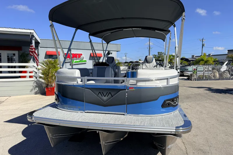 Slide: The Image of 2026 Avalon 2385 Venture 85 Quad Lounger Tri Toon, blue pontoon boat at dealership. - 3