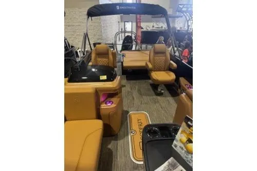 Slide: The Image of 2026 Godfrey Sweetwater 2286 SFLC pontoon boat interior with tan seating and modern amenities. - 3