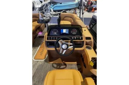 Slide: The Image of 2026 Godfrey Sweetwater 2286 SFLC boat interior with modern dashboard and tan seating. - 4