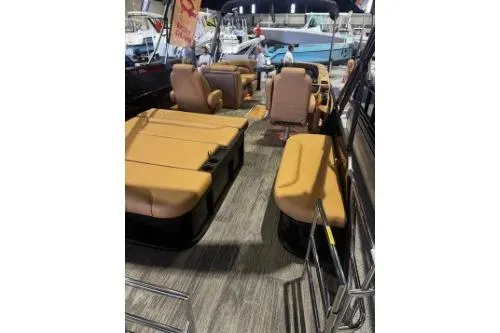 Slide: The Image of 2026 Godfrey Sweetwater 2286 SFLC pontoon boat with tan seating and spacious deck. - 5