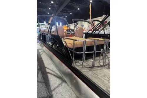 Slide: The Image of 2026 Godfrey Sweetwater 2286 SFLC pontoon boat displayed indoors, featuring comfortable seating. - 6
